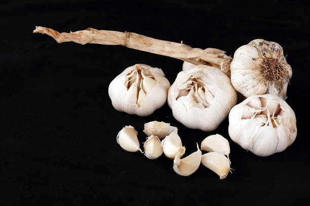 istock whole and garlic grains on black ground 977456066