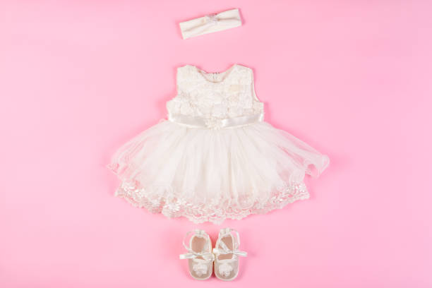 istock Beautiful baby dress with booties on a pink 977459554