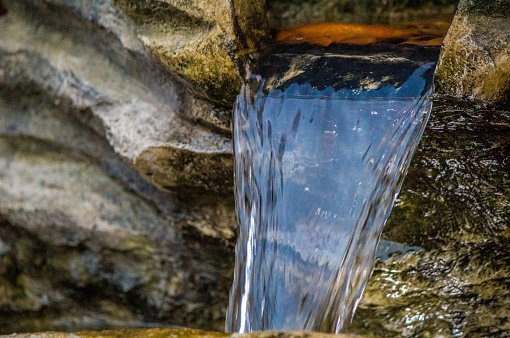 A close up view of a garden water feature cascading down.