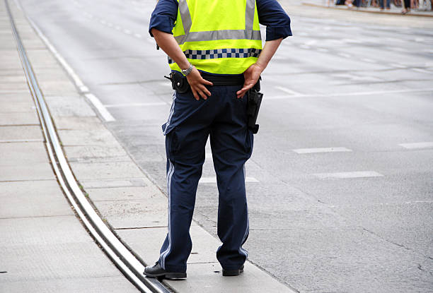 istock police officer standing in front of a crowd 97746666