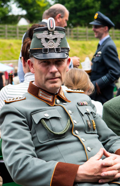 German Ordnungspolizei or rural policeman wearing a Shako Helmet. N.C.O. collar tabs indicating Gendarmerie while the shoulder boards indicates a rank of Meister. He also has a Wound Badge on his breast pocket. Photo taken at the Great Central Railway 1940s weekend. The Railway runs between Leicester and Loughborough in England.