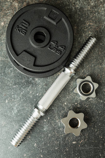 istock The metal dumbbell on old table. 977468008