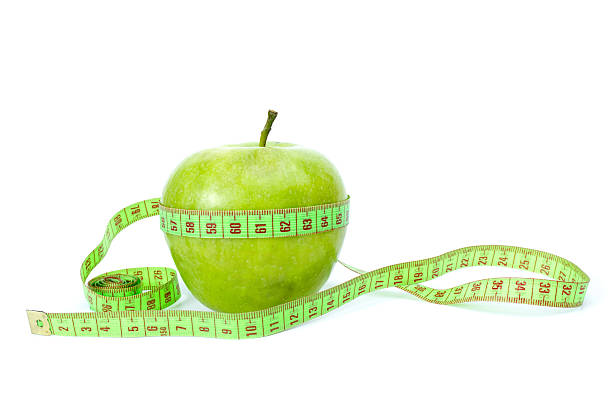 istock Green apple and measurement tape 97747094