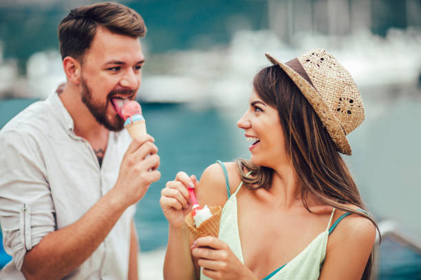 istock Happy couple having date and eating ice cream on vacation. 977475052