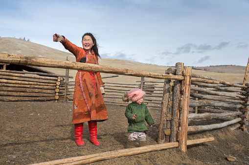 Hatgal, Mongolia, 3rd March 2018: mongolian lady with her kid near their nomadic home in a steppe of northern Mongolia