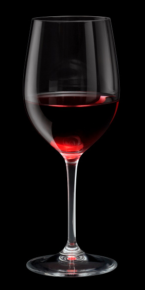 half filled glass of red wine in black back, with clipping path