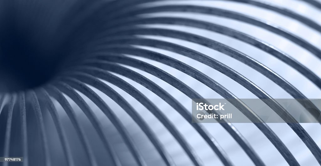 Spiral colors, shapes and background  blue toned detail of a metal coil Abstract Stock Photo
