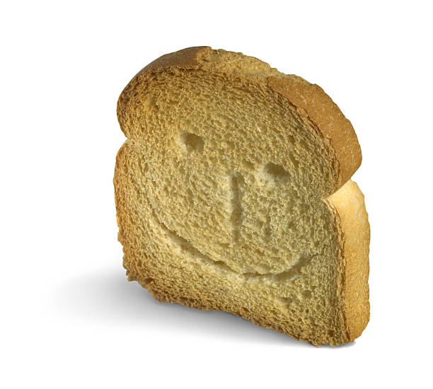 smiling rusk slice of rusk isolated on white with carved smiley on it´s surface zwieback toast stock pictures, royalty-free photos & images