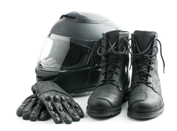 Motorcycle helmet, gloves and boots isolated on white background.