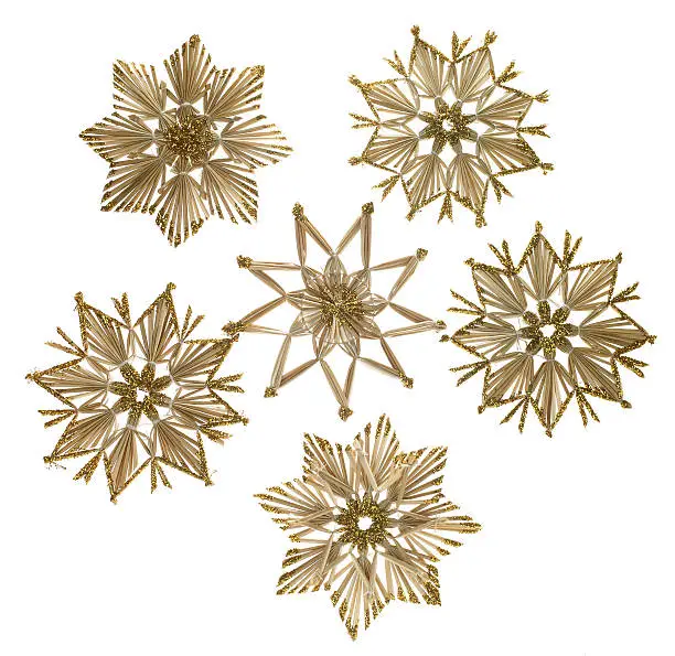 Studio photography of a arrangement of straw stars isolated on white
