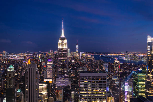 Empire State Building and New York Skyline in Blue Hou Empire State Building and New York Skyline in Blue Hour from Top of the Rock Observation Deck new york city built structure building exterior aerial view stock pictures, royalty-free photos & images