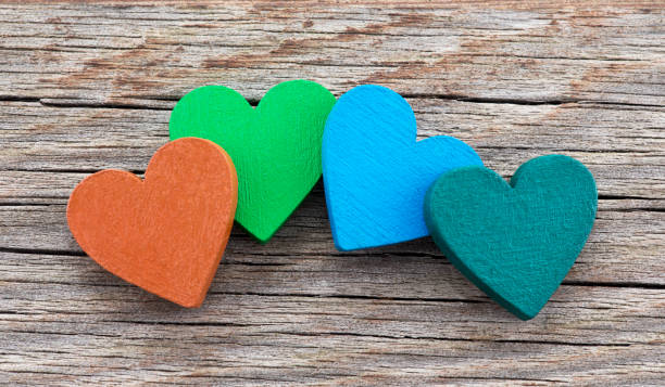 istock Colorful hearts on wooden background 977496090