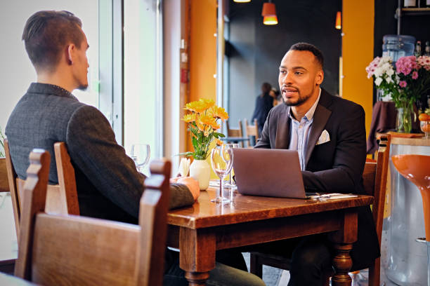 istock Men having a business meeting in a restaurant. 977496926