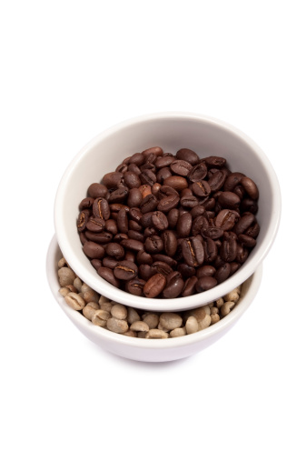 Roasted and green arabica coffee beans in cups isolated on plain background, top view, Clipping path included.