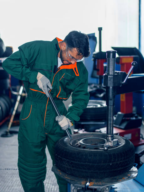 istock Mechanic removes car tire 977502506
