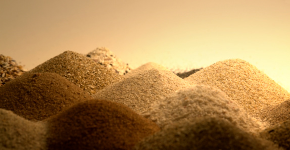 dune-like multicolored sand piles in warm yellow ambiance