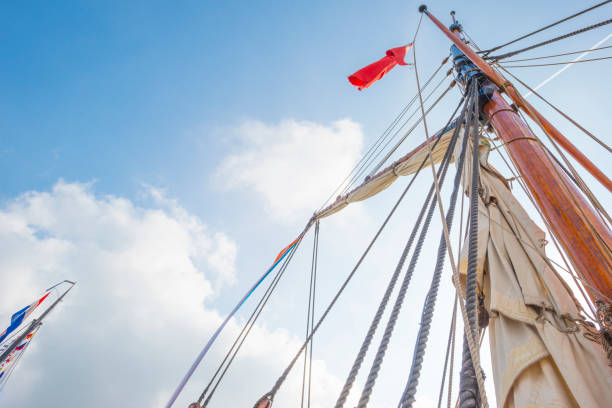 Motion blur on the flag and lensflare is visible. beach. The red flag indicates stormy wheather and therefore it is forbidden to go on the pier. Wide angle image.