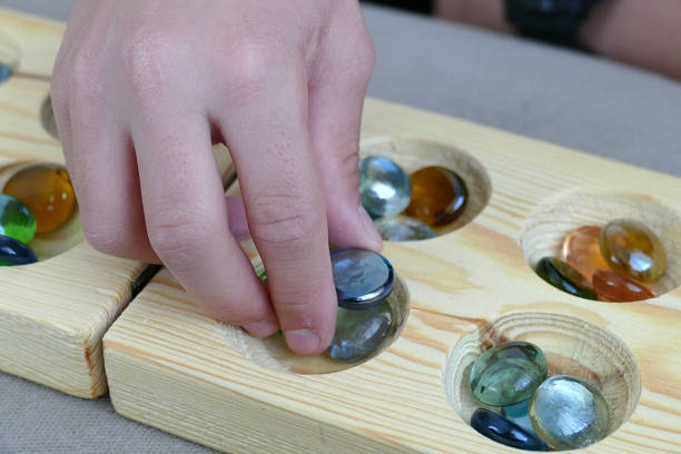 istock kids playing mancala, playing mancala, 977515322