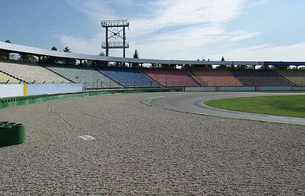 detail of a racetrack named "Hockenheimring" in Southern Germany showing a multicolored tribune and the parcours with run-off area