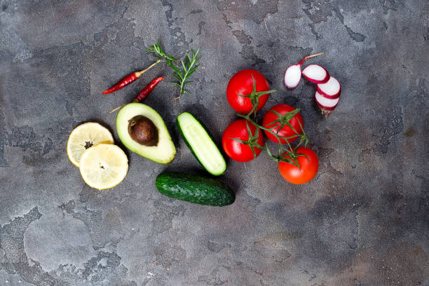 istock Fresh organic ingredients for salad making on stone background, top view. 977536364