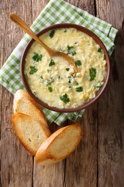 istock Italian egg soup stracciatella with farfalline pasta and parmesan close-up. Vertical top view 977541432