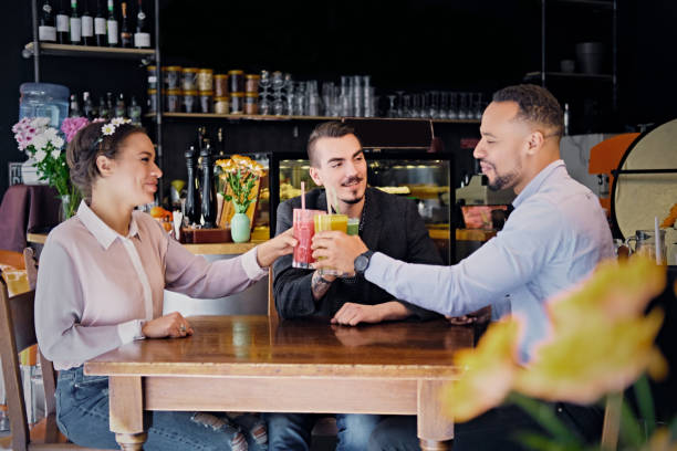 istock Friends drinking coctails in a cafe. 977544478