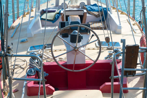 Steering wheel on the yacht with blue sea water background