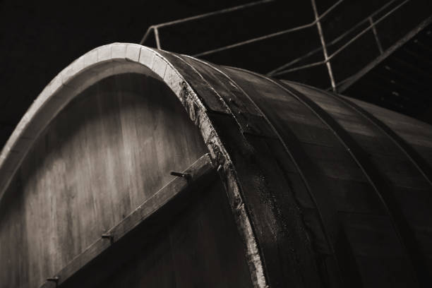 Old wooden barrel in dark winery, close up Old wooden barrel in dark winery, close up monochrome photo with selective focus inkerman stock pictures, royalty-free photos & images