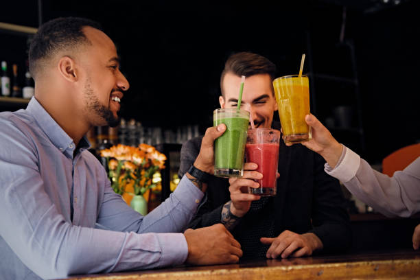 istock Friends drinking coctails in a cafe. 977574302