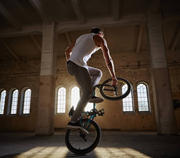 istock BMX stunt and jump riding in a hall with sunlight. 977581618