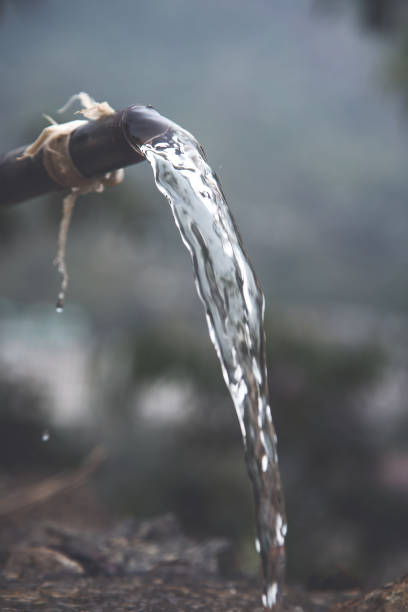 Water Flowing Out Of Pipe Fresh village water flowing out from a broken steel pipe broken spring stock pictures, royalty-free photos & images