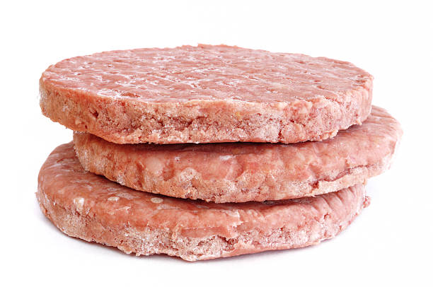 istock Three stacked frozen, uncooked hamburger patties 97759526