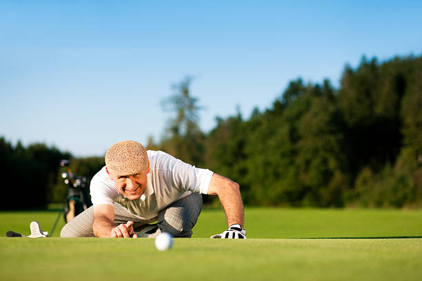 istock Senior golf player measuring hole distance 97759646