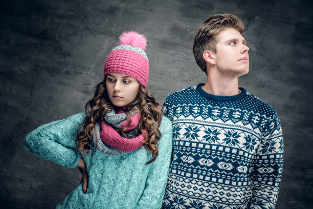 istock Urban couple in sweaters on grey background. 977602572