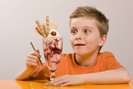 Closeup portrait of happy little blonde male kid boy in white tshirt, laughing while standing isolated on yellow background. People, childhood, lifestyle concept