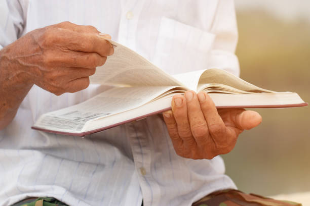 istock Adult education Learning Studying concept : Asian Elderly man sitting reading book at riverside outdoor for learning or relax by self 977621478