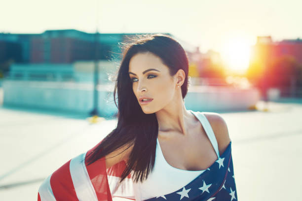 istock American beauty covered by star spangled banner in sunset 977626640