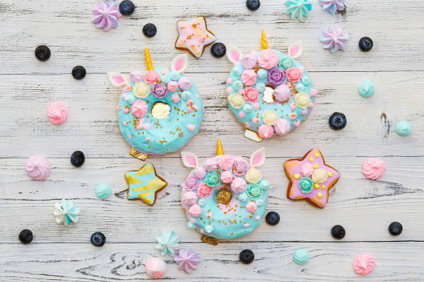 istock Colorful donuts on white wooden background 977632058
