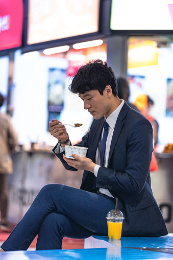 Businessman on the go in Seoul downtown commuting to work. South Korea lifestyle.