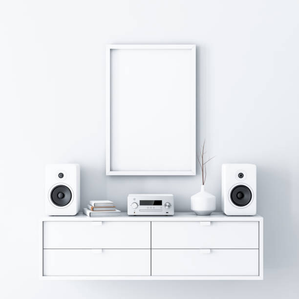 istock Vertical poster Mockup with white frame hanging on the wall, audio micro system on bureau 977645464