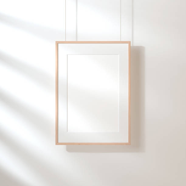 istock White poster with wooden frame Mockup hanging on the wall 977653834