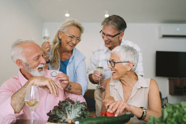 istock Senior couples preparing food and laughing 977666546
