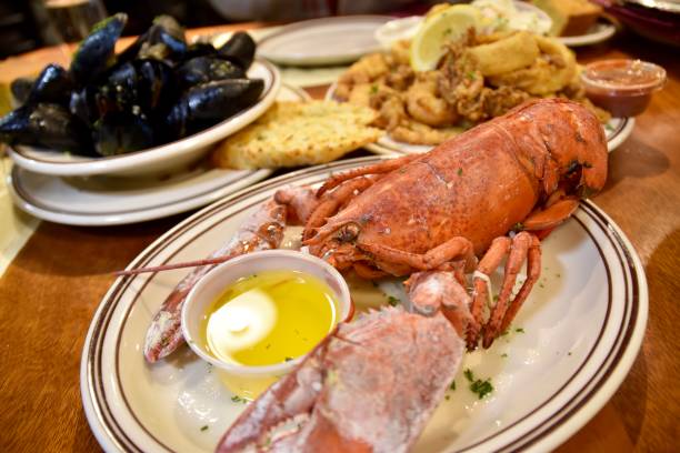 Boston Lobster and other seafood plates. Union Oyster House, Boston, USA. lobster seafood photos stock pictures, royalty-free photos & images
