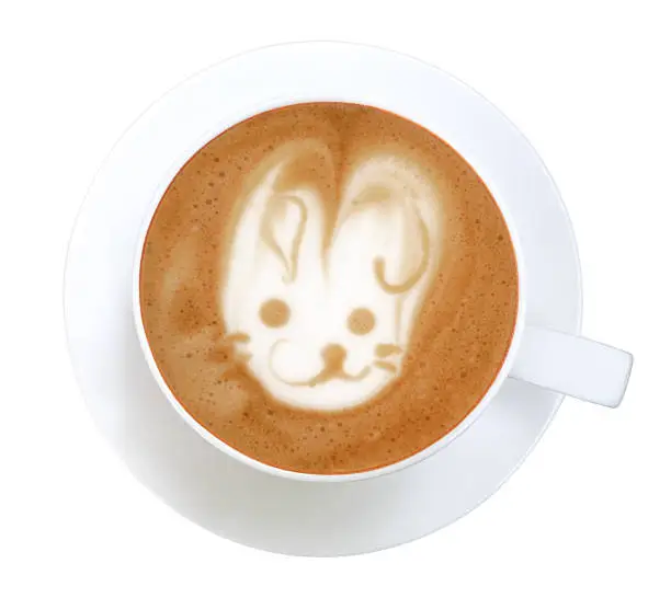 Top view of hot coffee cappuccino latte art rabbit shape foam isolated on white background, clipping path included