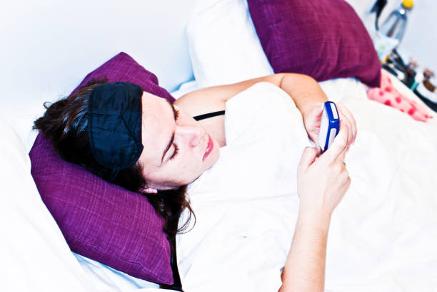 istock Young Woman On Phone In Bed 977670896