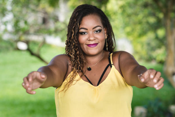 istock Young plus size woman with arms open to embrace 977680122