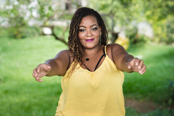 istock Young plus size woman with arms open to embrace 977680154