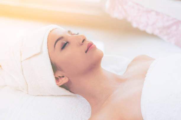 istock Relaxed young woman lying on spa bed for massage. 977684444