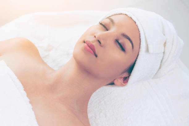 istock Relaxed young woman lying on spa bed for massage. 977684448