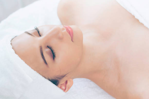 istock Relaxed young woman lying on spa bed for massage. 977684472